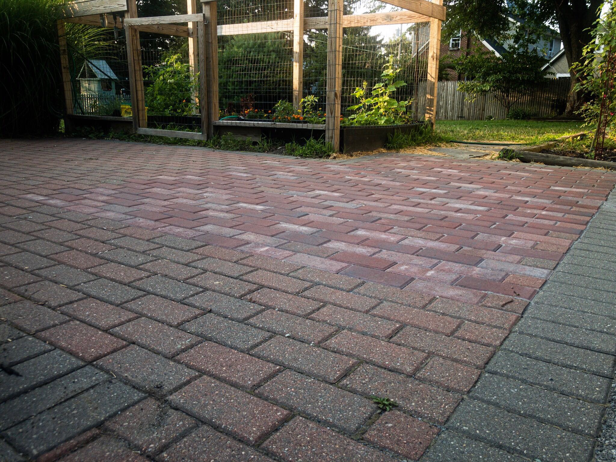 A natural stone patio surrounded by mature plantings, designed and built by Peak Landscaping